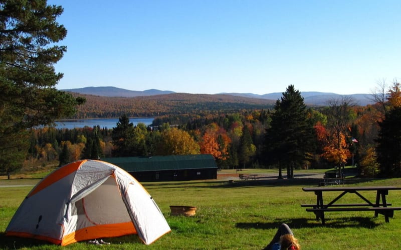 Camping tent with fall foliage, lake, and mountains at Ramblewood