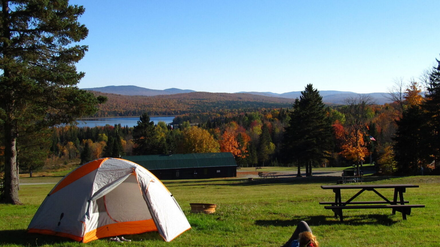 Tent camping with fall foliage and lake view